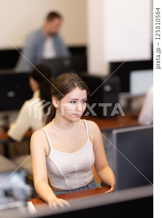Young woman working on computer in office Young woman working on computer in office 125810564