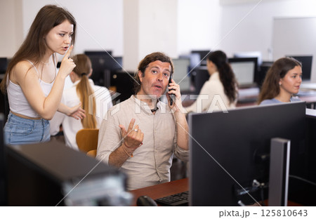 Female teacher makes remark to man student, asks to stop talking on phone during lesson 125810643
