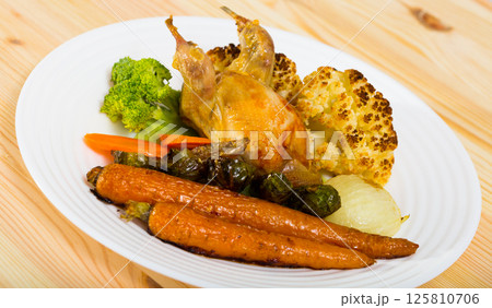 Broiled quail with baked vegetables Broiled quail with baked vegetables 125810706