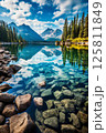 The crystal clear water of a mountain lake reflects the sky above 125811849