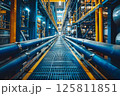 Blue and yellow industrial pipes and walkway 125811851