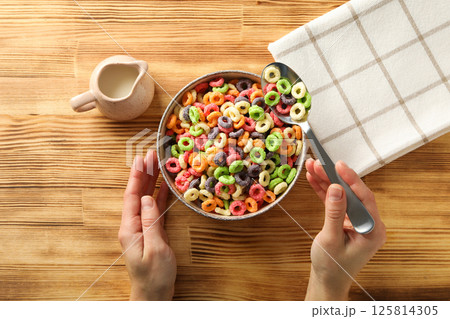 Colorful corn flakes in a bowl on a wooden background Colorful corn flakes in a bowl on a wooden background 125814305