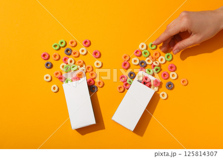 Colorful corn flakes on a yellow background 125814307