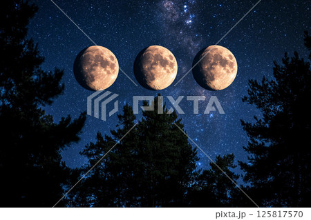 Three full moons shining brightly in a starry night sky 125817570