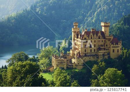 Castle with brightly shining walls stands cheerfully against a backdrop of majestic mountains and clear blue skies 125817741