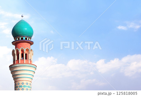 Horizontal banner with minaret of Friday Mosque against a blue sky backdrop with white clouds, Ardabil, Iran. Topic of vacation, travel, trip abroad on vacation, cruises and tours. Copy space for text Horizontal banner with minaret of Friday Mosque against a blue sky backdrop with white clouds, Ardabil, Iran. Topic of vacation, travel, trip abroad on vacation, cruises and tours. Copy space for text 125818005