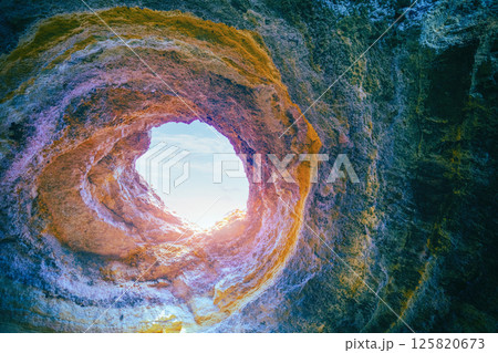 Coastal rocky seascape, hole of Benagil cave in Algarve region in Atlantic ocean, Portugal, Europe 125820673