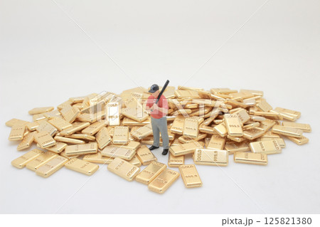 Miniature Figure of Golfer Surrounded by Stacked Gold Bars Miniature Figure of Golfer Surrounded by Stacked Gold Bars 125821380