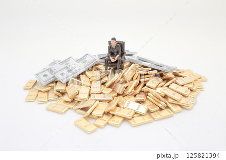 Figure Amidst Gold and Money Representing Wealth and Luxury 125821394