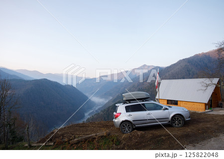 Spectacular landscape of mountains, grey car, and house in Variaki, Georgia 125822048