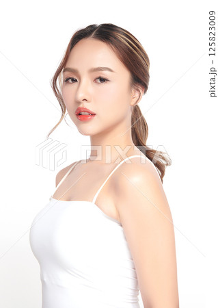 A beautiful young Asian woman with clean, fresh skin against a white background. Skincare, facial treatment, cosmetology, beauty, and spa. An elegant portrait of an Asian woman. A beautiful young Asian woman with clean, fresh skin against a white background. Skincare, facial treatment, cosmetology, beauty, and spa. An elegant portrait of an Asian woman. 125823009