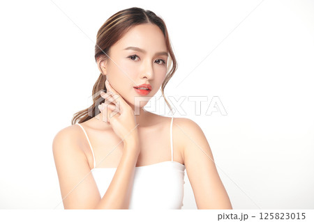 A beautiful young Asian woman with clean, fresh skin against a white background. Skincare, facial treatment, cosmetology, beauty, and spa. An elegant portrait of an Asian woman. A beautiful young Asian woman with clean, fresh skin against a white background. Skincare, facial treatment, cosmetology, beauty, and spa. An elegant portrait of an Asian woman. 125823015