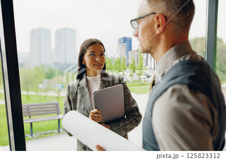 A business meeting is taking place among professionals in a modern and stylish office space A business meeting is taking place among professionals in a modern and stylish office space 125823312