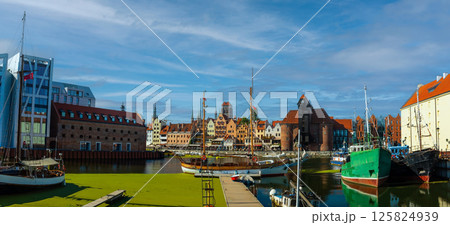 Scenic view of a marina on a sunny day, featuring a variety of yachts docked along the pier in Gdansk, Poland. Picturesque waterfront scene. 125824939