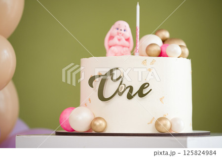 First birthday cake with gold and pink decorations. A sweet celebration. First birthday cake with gold and pink decorations. A sweet celebration. 125824984