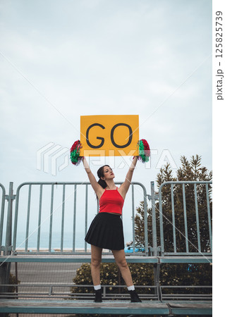 Cheerleader Girl Cheers Her Heart Basketball Team On The Stands 125825739
