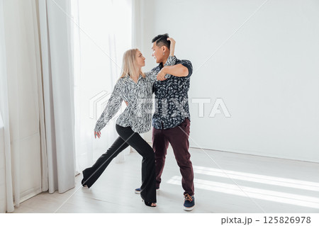 Man and woman dancing together to music Man and woman dancing together to music 125826978
