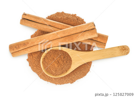 Cinnamon sticks with powder in wooden spoon isolated on white background. Top view. Flat lay. Cinnamon sticks with powder in wooden spoon isolated on white background. Top view. Flat lay. 125827009