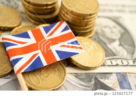 UK United Kingdom flag on coin and banknote money, finance trading investment business currency. UK United Kingdom flag on coin and banknote money, finance trading investment business currency. 125827177