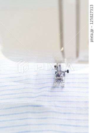 sewing machine with a cloth under a steel needle. manufacture of clothing. 125827313