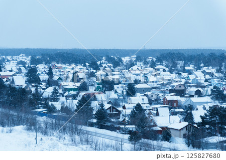 A peaceful village nestles under a thick layer of snow, with rooftops covered and smoke gently rising from chimneys, evoking a cozy winter atmosphere. A peaceful village nestles under a thick layer of snow, with rooftops covered and smoke gently rising from chimneys, evoking a cozy winter atmosphere. 125827680
