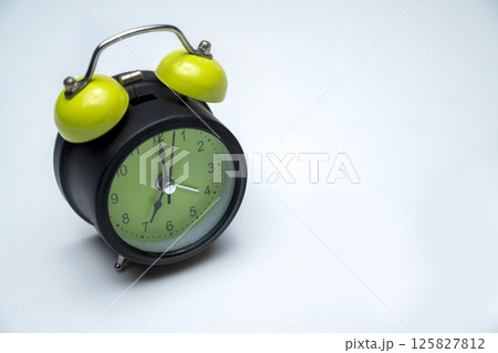 Green alarm clock on white background. Empty area for copy space. Concept of time, reminder, or deadline 125827812