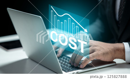 Businessman typing on a laptop with a downward chart of cost. Technology innovation on a virtual screen. Concept of cost reduction, business performance management, and improvement 125827888