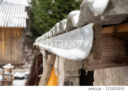 Rural snow-covered roofs in a winter landscape Rural snow-covered roofs in a winter landscape 125828241