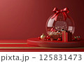 3D rendering of a Christmas decoration inside a glass ball with a gift box on a red background, a podium for product presentation. A New Year's atmosphere. 125831473