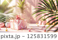 3D rendering of a gift box podium background with a pastel pink color, geometric shapes, and palm leaf decorations for a birthday party or special event 125831599