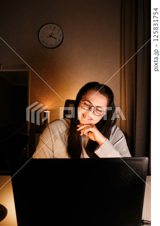 Smiling friendly female freelancer having online conference call with client sitting at home. Remote job concept. Smiling friendly female freelancer having online conference call with client sitting at home. Remote job concept. 125831754