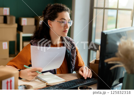 Woman working in a warehouse 125832318