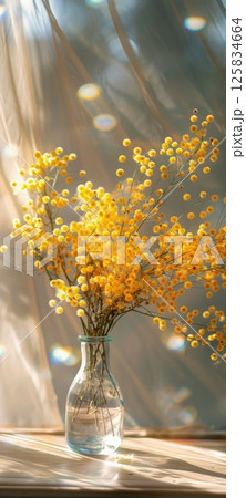Sunny Yellow Mimosa Flowers in Glass Vase Indoors Sunny Yellow Mimosa Flowers in Glass Vase Indoors 125834664
