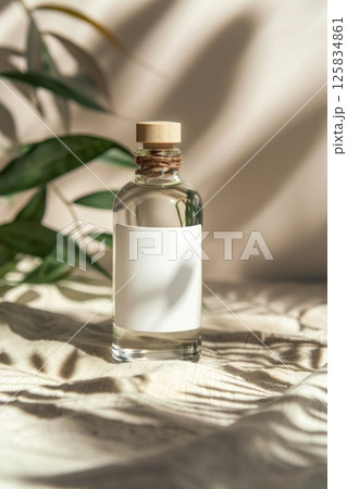 Amber Glass Bottle with Blank Label on Natural Background Amber Glass Bottle with Blank Label on Natural Background 125834861