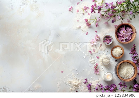 An assortment of herbal bath salts, fresh flowers, and essential oils laid out An assortment of herbal bath salts, fresh flowers, and essential oils laid out 125834900