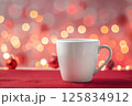 Cozy Winter Atmosphere with Warm Mug and Soft Bokeh Lights 125834912