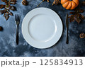 Autumn-Themed Table Setting with Pumpkins and Fall Leaves 125834913