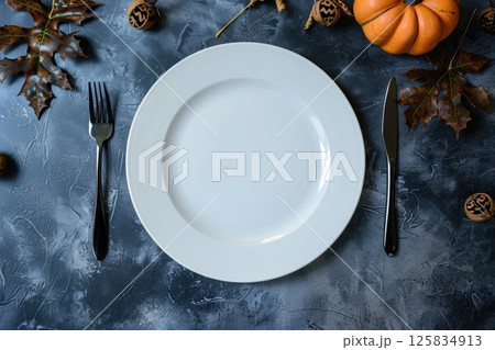 Autumn-Themed Table Setting with Pumpkins and Fall Leaves 125834913