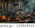 Eerie Halloween Dinner Table with Skull, Pumpkins, and Candles 125834914