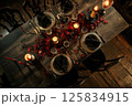Warm Autumn Evening Dinner Party Table Setting with Candlelight 125834915