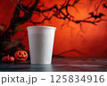 Spooky Season Coffee Concept with Halloween Pumpkins and Orange Backdrop 125834916