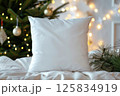 Cozy White Pillow on Fur Blanket with Christmas Tree Lights Background 125834919