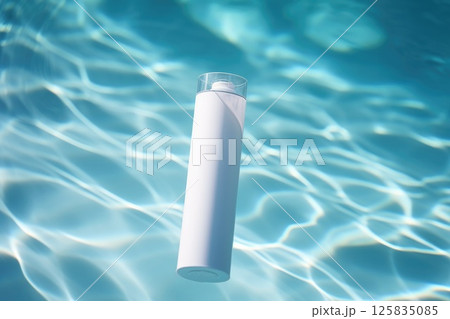 White blank cosmetic bottle tube mock up lies on the water surface 125835085