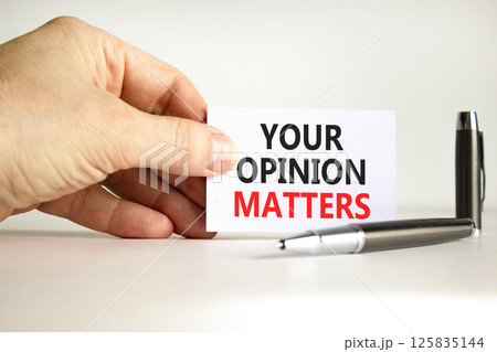 Your opinion matters symbol. Concept words Your opinion matters on beautiful white card. Beautiful white background. Businessman hand. Business your opinion matters concept. Copy space. 125835144