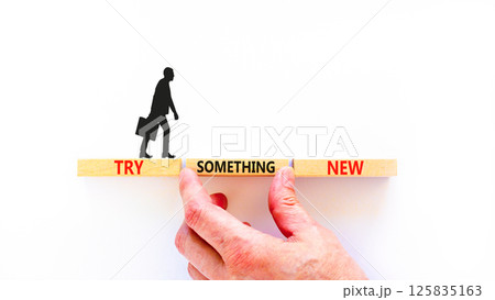 Try something new symbol. Concept words Try something new on beautiful block. Businessman's hand. Beautiful white background. Business motivational lifestyle try something new concept. Copy space. 125835163