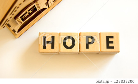 Hope symbol. Concept word Hope on beautiful wooden blocks. Beautiful wooden house. Beautiful white table white background. Business, lifestyle, support and hope concept. Copy space. 125835200