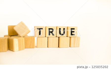 True symbol. Concept word True on beautiful wooden blocks. Beautiful white table white background. Business, lifestyle, support and true concept. Copy space. True symbol. Concept word True on beautiful wooden blocks. Beautiful white table white background. Business, lifestyle, support and true concept. Copy space. 125835202