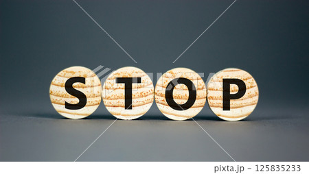 Stop symbol. Concept word Stop on beautiful wooden circles. Beautiful grey table grey background. Business, lifestyle, support and stop concept. Copy space. Stop symbol. Concept word Stop on beautiful wooden circles. Beautiful grey table grey background. Business, lifestyle, support and stop concept. Copy space. 125835233