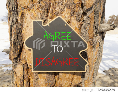 Agree to disagree symbol. Concept words Agree to disagree on beautiful blackboard. Beautiful old tree and sand beach background. Business and agree to disagree concept. Copy space. 125835279