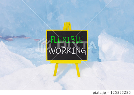 Flexible working symbol. Concept words Flexible working on beautiful yellow blackboard. Beautiful blue ice background. Business flexible working concept. Copy space. 125835286